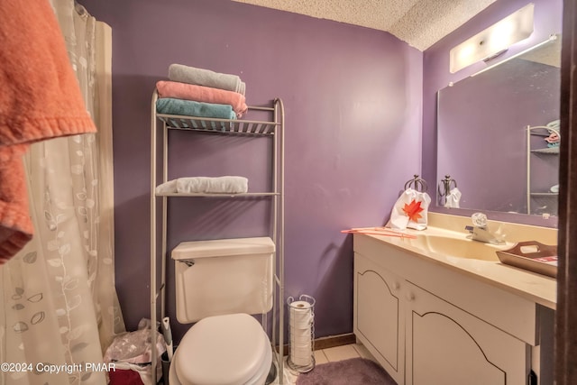 full bathroom featuring toilet, vanity, a textured ceiling, and tile patterned floors