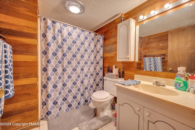 bathroom featuring a textured ceiling, toilet, wooden walls, vanity, and a shower with curtain