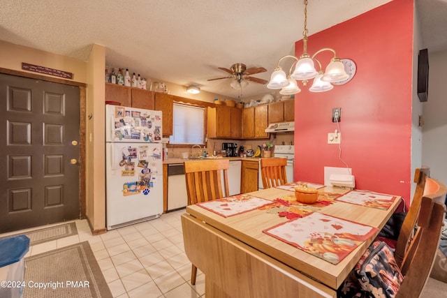 kitchen with light countertops, a textured ceiling, white appliances, under cabinet range hood, and ceiling fan with notable chandelier