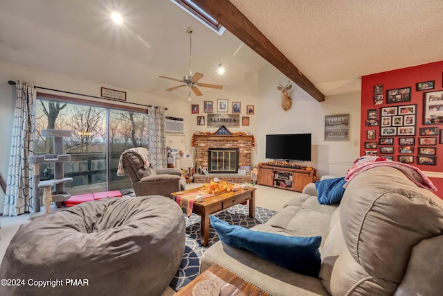 living area with a textured ceiling, vaulted ceiling with skylight, a brick fireplace, and carpet