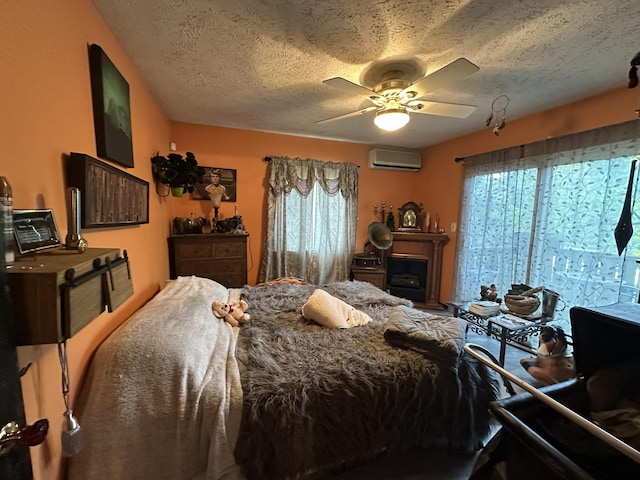 152 Fairview Ave, Mount Pocono, PA 18344 - bedroom with a wall unit AC, a textured ceiling, and a ceiling fan
