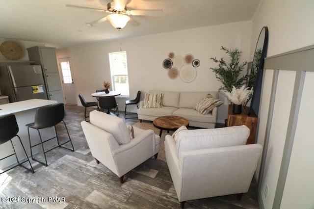 living area featuring a ceiling fan and wood finished floors