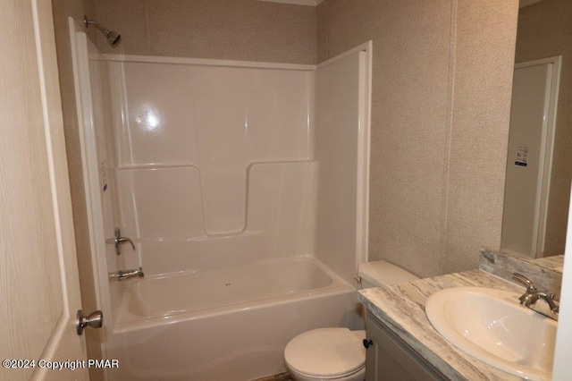 bathroom with bathtub / shower combination, vanity, and toilet