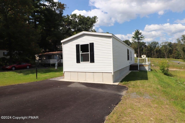 view of property exterior with a lawn