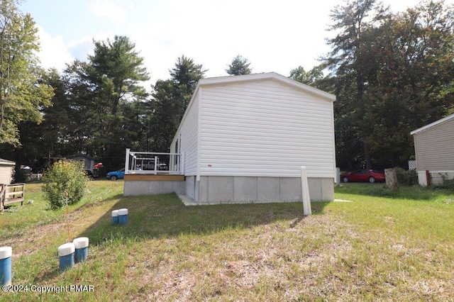 view of property exterior featuring a lawn