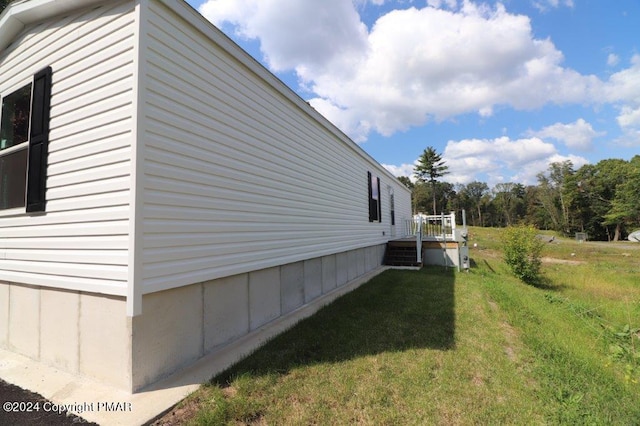 view of home's exterior with a yard