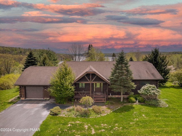 106 Windsor Dr, Lake Ariel, PA 18436 - log cabin with log siding, a front yard, driveway, an attached garage, and covered porch