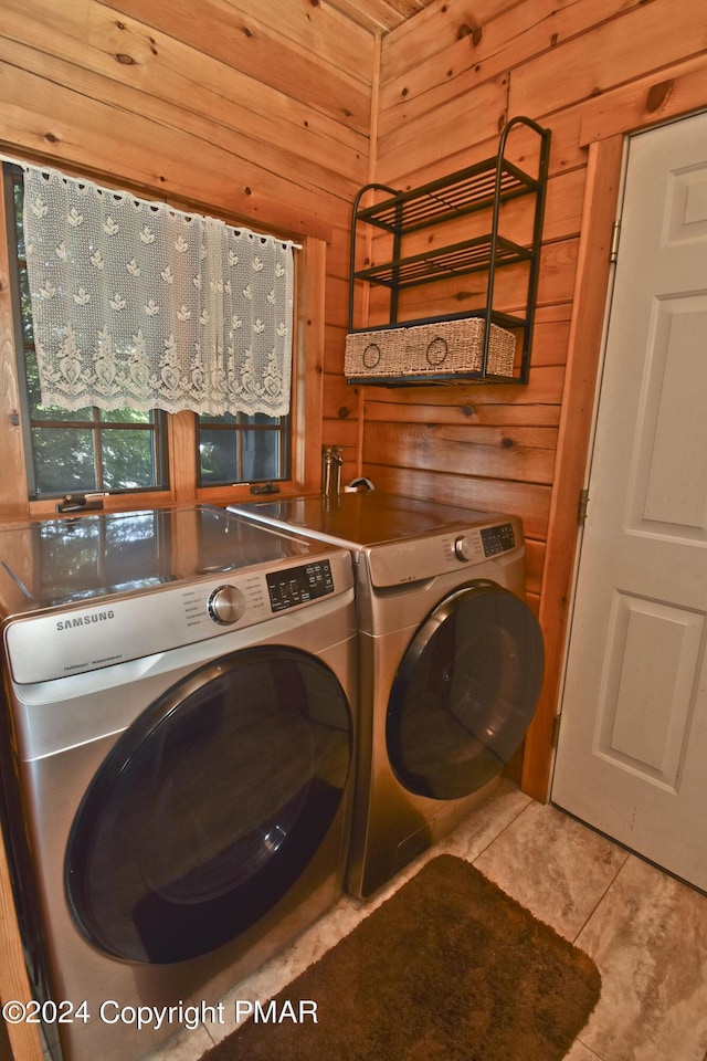 106 Windsor Dr, Lake Ariel, PA 18436 - laundry area featuring washer and clothes dryer, wooden walls, and tile patterned floors