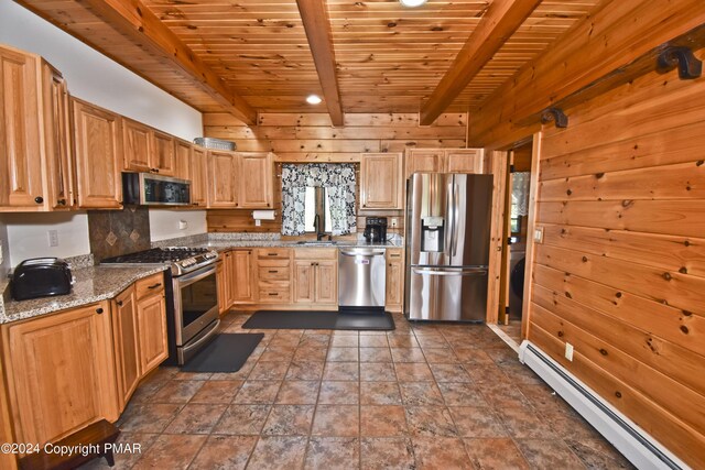 106 Windsor Dr, Lake Ariel, PA 18436 - kitchen with appliances with stainless steel finishes, a baseboard heating unit, a wood ceiling with exposed beams, wooden walls, and light stone counters