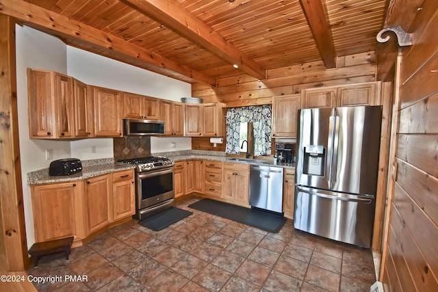 106 Windsor Dr, Lake Ariel, PA 18436 - kitchen featuring stainless steel appliances, a wood ceiling with exposed beams, dark stone finish flooring, light stone countertops, and wooden walls
