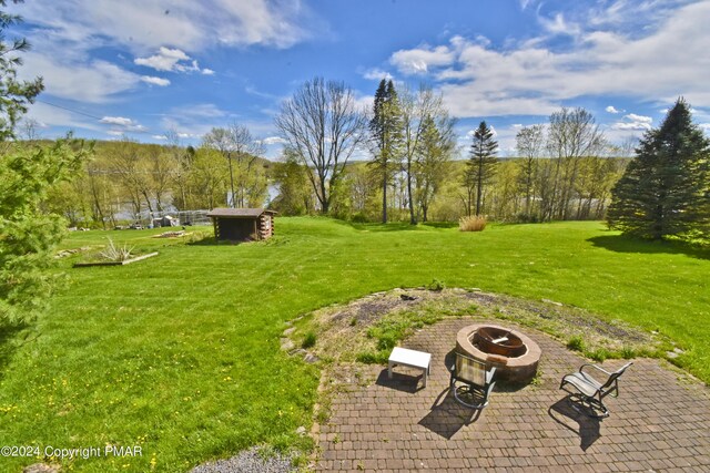 106 Windsor Dr, Lake Ariel, PA 18436 - view of green lawn with a fire pit, a patio, and a shed