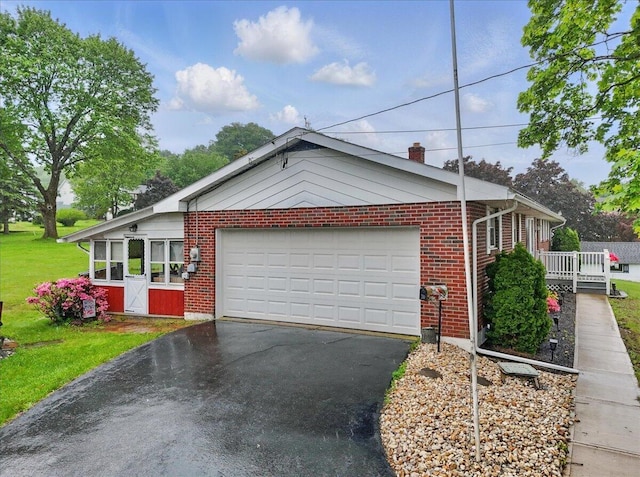 20 Cleveland Ave, East Bangor, PA 18013 - view of front of property with driveway, an attached garage, brick siding, a front lawn, and a chimney