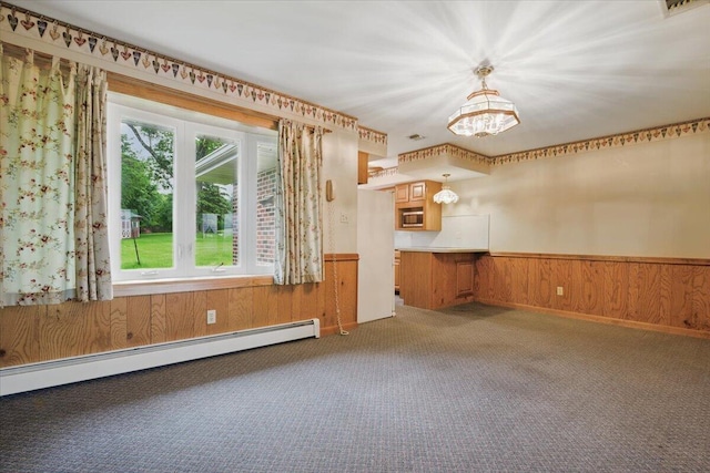 20 Cleveland Ave, East Bangor, PA 18013 - carpeted empty room with a baseboard radiator, a chandelier, a wainscoted wall, and wood walls