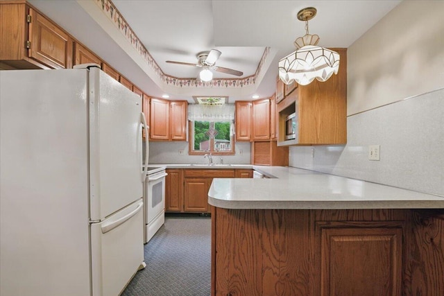 20 Cleveland Ave, East Bangor, PA 18013 - kitchen featuring white appliances, a peninsula, a ceiling fan, light countertops, and a sink