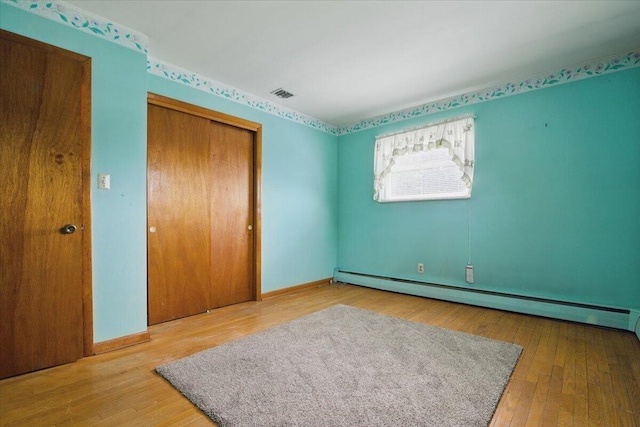 20 Cleveland Ave, East Bangor, PA 18013 - unfurnished bedroom with a baseboard radiator, a closet, wood-type flooring, and baseboards