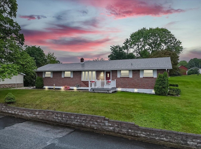 20 Cleveland Ave, East Bangor, PA 18013 - ranch-style home with a front yard, brick siding, a chimney, and a deck