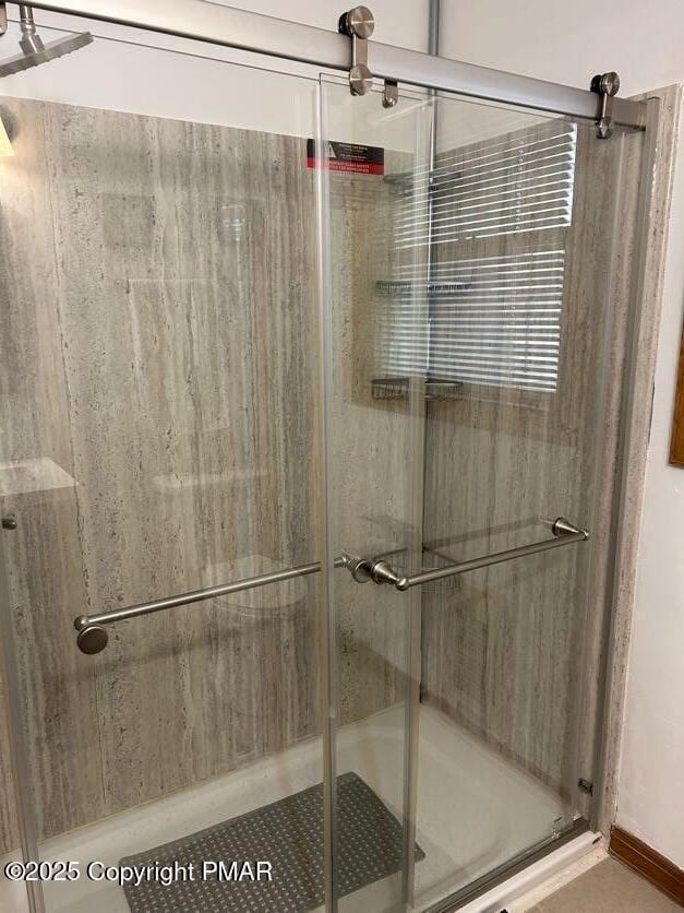 bathroom with a shower with shower door