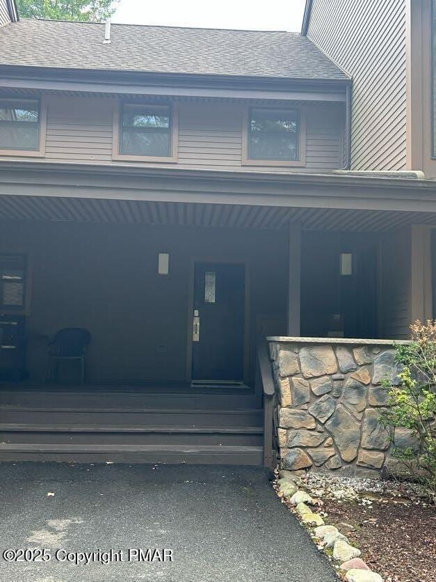 doorway to property featuring covered porch