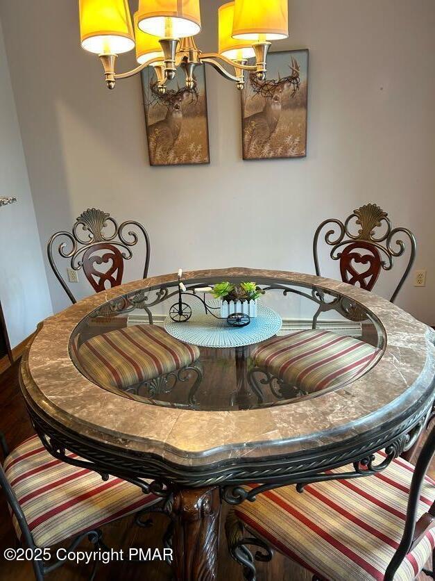 dining area with an inviting chandelier