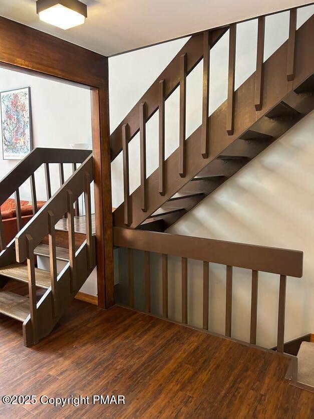 stairway featuring hardwood / wood-style flooring