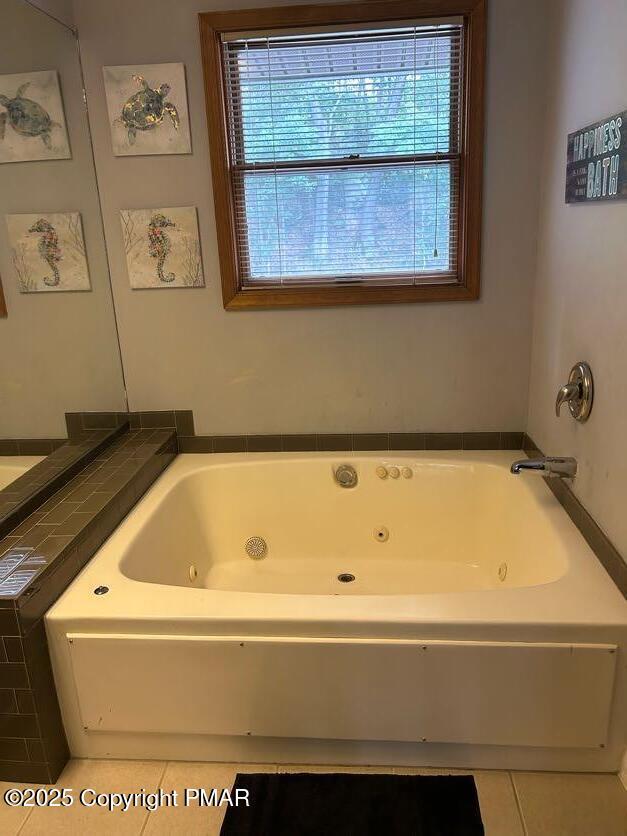 bathroom with tile patterned floors and a bathtub