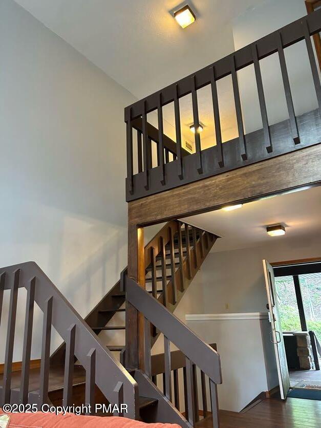 stairs featuring wood finished floors