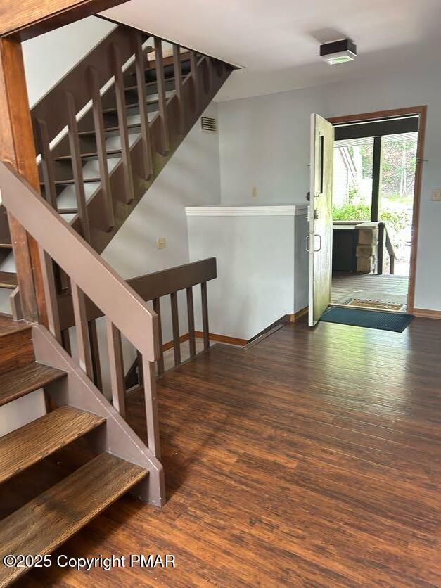 stairway with hardwood / wood-style floors