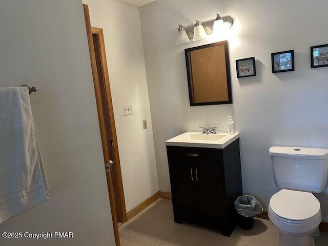 bathroom with vanity, tile patterned floors, and toilet