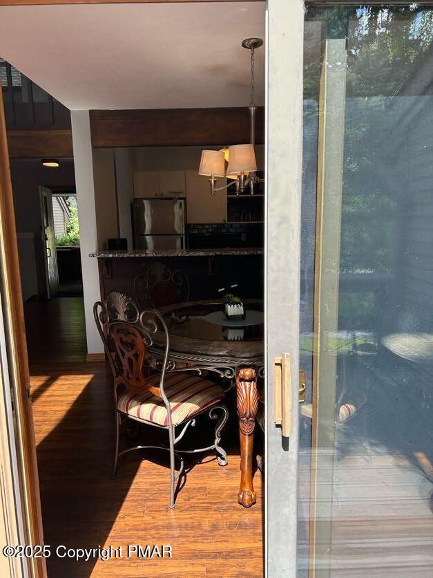 dining area featuring a notable chandelier and wood finished floors