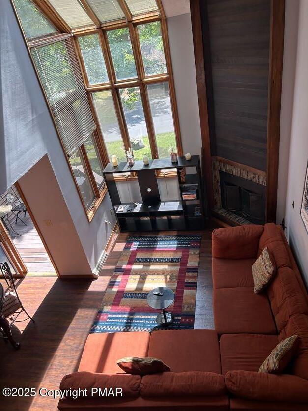 living room with a large fireplace and wood finished floors