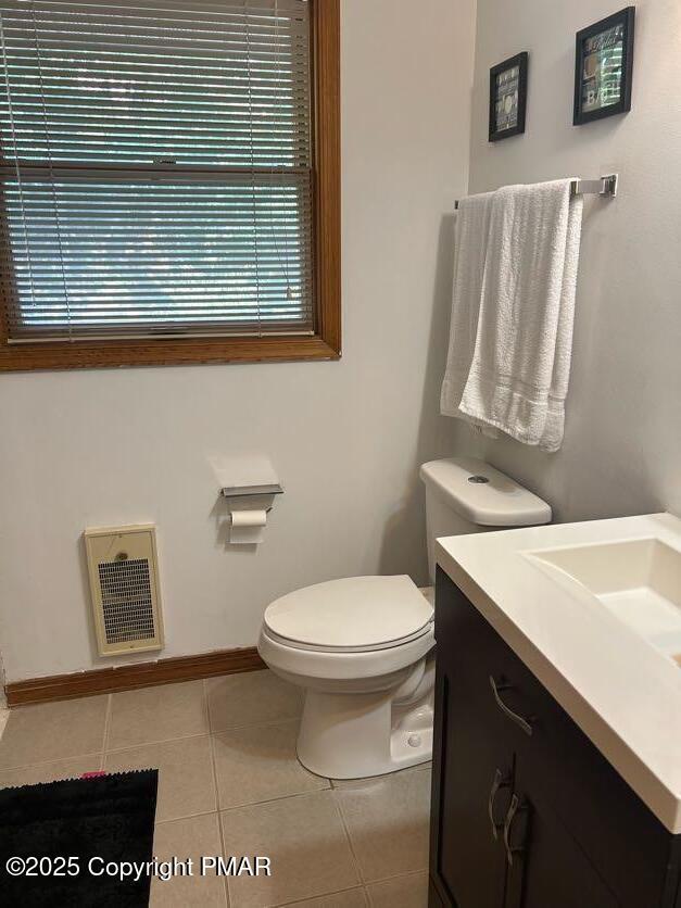 bathroom with vanity, toilet, and tile patterned flooring