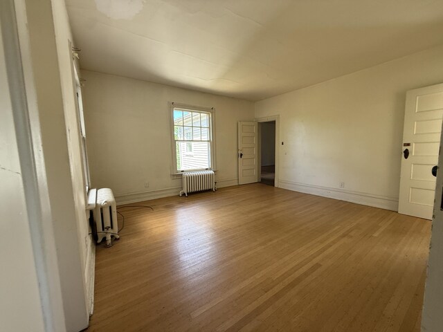 712 Thomas St, Stroudsburg, PA 18360 - unfurnished room featuring radiator, light wood finished floors, and baseboards