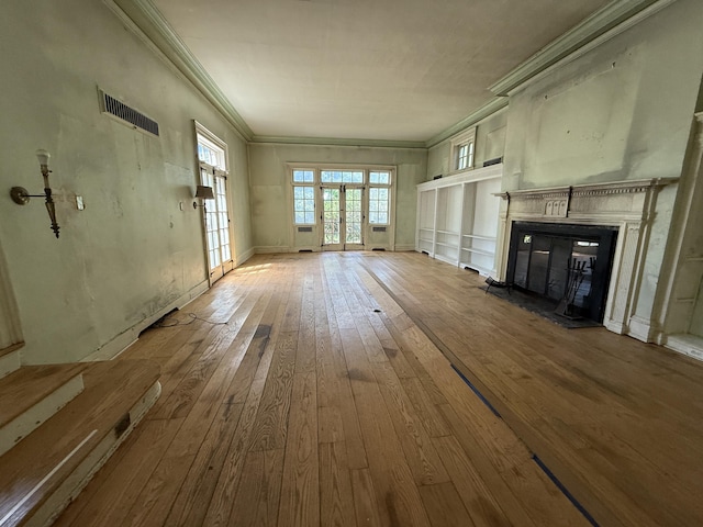 712 Thomas St, Stroudsburg, PA 18360 - unfurnished living room featuring wood-type flooring, crown molding, and a glass covered fireplace