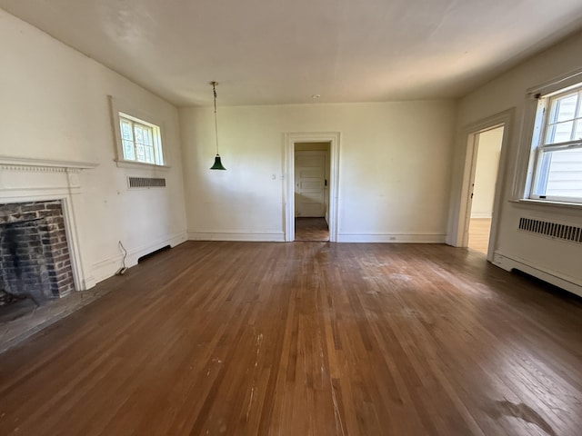 712 Thomas St, Stroudsburg, PA 18360 - unfurnished living room with dark wood finished floors, a fireplace, and baseboards