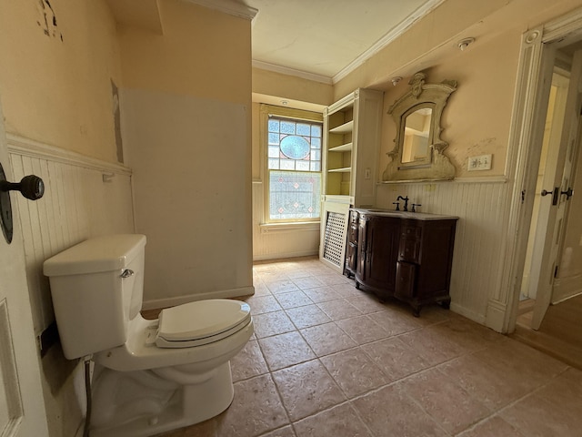 712 Thomas St, Stroudsburg, PA 18360 - bathroom with wainscoting, ornamental molding, toilet, wood walls, and vanity