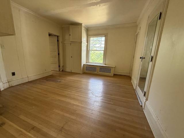 712 Thomas St, Stroudsburg, PA 18360 - empty room with light wood-style floors, radiator, crown molding, and baseboards