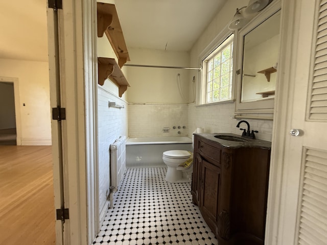 712 Thomas St, Stroudsburg, PA 18360 - full bath featuring radiator heating unit, toilet, vanity, shower / tub combination, and a wainscoted wall