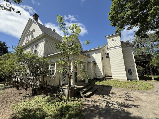 712 Thomas St, Stroudsburg, PA 18360 - view of front of property featuring stairway, a chimney, a deck, and a patio area