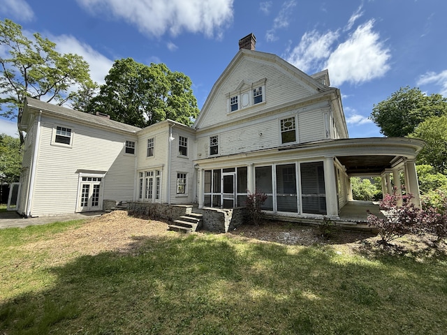 712 Thomas St, Stroudsburg, PA 18360 - back of property with a sunroom, a chimney, a lawn, and french doors