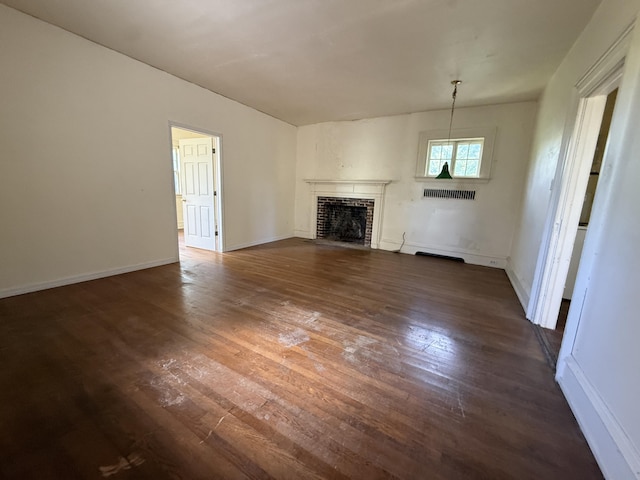 712 Thomas St, Stroudsburg, PA 18360 - unfurnished living room with a fireplace, dark wood finished floors, and baseboards