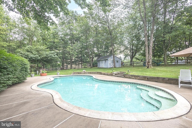 16 Kiloran Wynd Rd, Glenmoore, PA 19343 - outdoor pool featuring a fenced backyard, a storage shed, view of wooded area, and a patio area