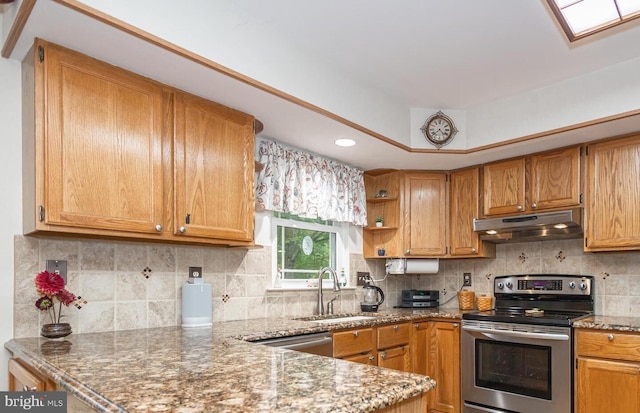 16 Kiloran Wynd Rd, Glenmoore, PA 19343 - kitchen featuring appliances with stainless steel finishes, under cabinet range hood, light stone counters, a peninsula, and decorative backsplash
