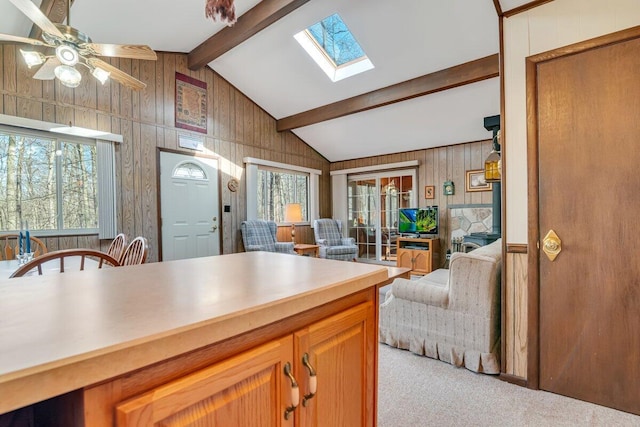 144 Beech Ln, Pocono Lake, PA 18347 - kitchen with open floor plan, carpet, healthy amount of natural light, a skylight, and wood walls