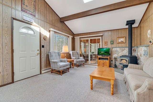 144 Beech Ln, Pocono Lake, PA 18347 - carpeted living area with a wood stove, wood walls, and a baseboard radiator