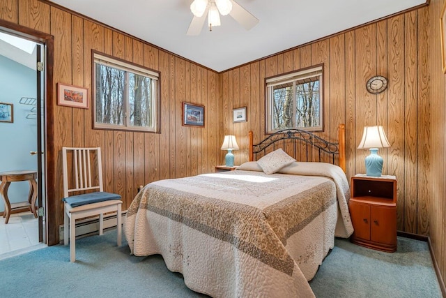 144 Beech Ln, Pocono Lake, PA 18347 - bedroom with carpet flooring, wood walls, baseboard heating, and ceiling fan