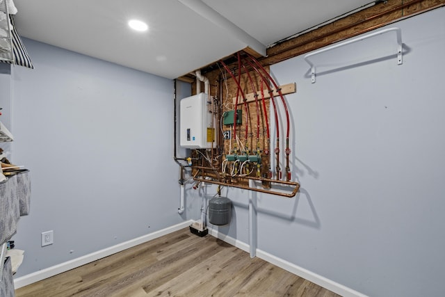 19 Conservancy Ct, Gouldsboro, PA 18424 - laundry room with water heater, light wood-style flooring, baseboards, and recessed lighting