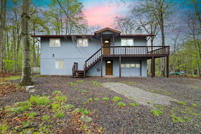 19 Conservancy Ct, Gouldsboro, PA 18424 - rear view of house featuring a chimney, stairs, driveway, and a deck