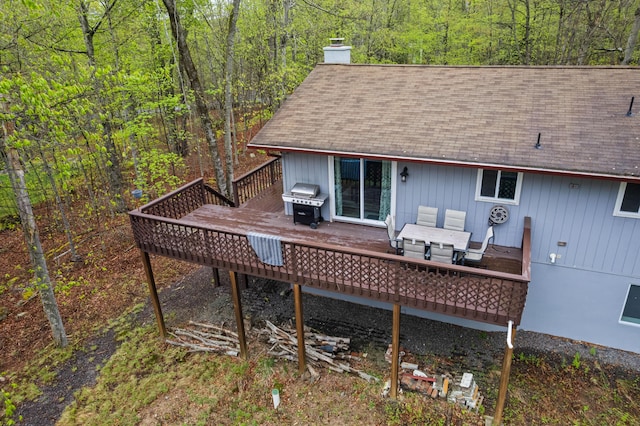 19 Conservancy Ct, Gouldsboro, PA 18424 - back of property featuring a chimney, a wooden deck, roof with shingles, and a wooded view