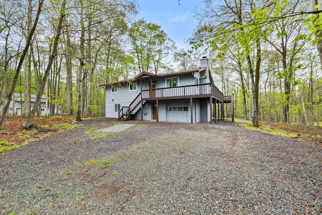 19 Conservancy Ct, Gouldsboro, PA 18424 - view of front of home featuring stairway, a chimney, driveway, and a garage