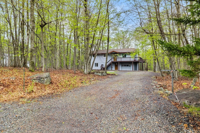 19 Conservancy Ct, Gouldsboro, PA 18424 - view of front facade with stairway, driveway, a garage, and a deck
